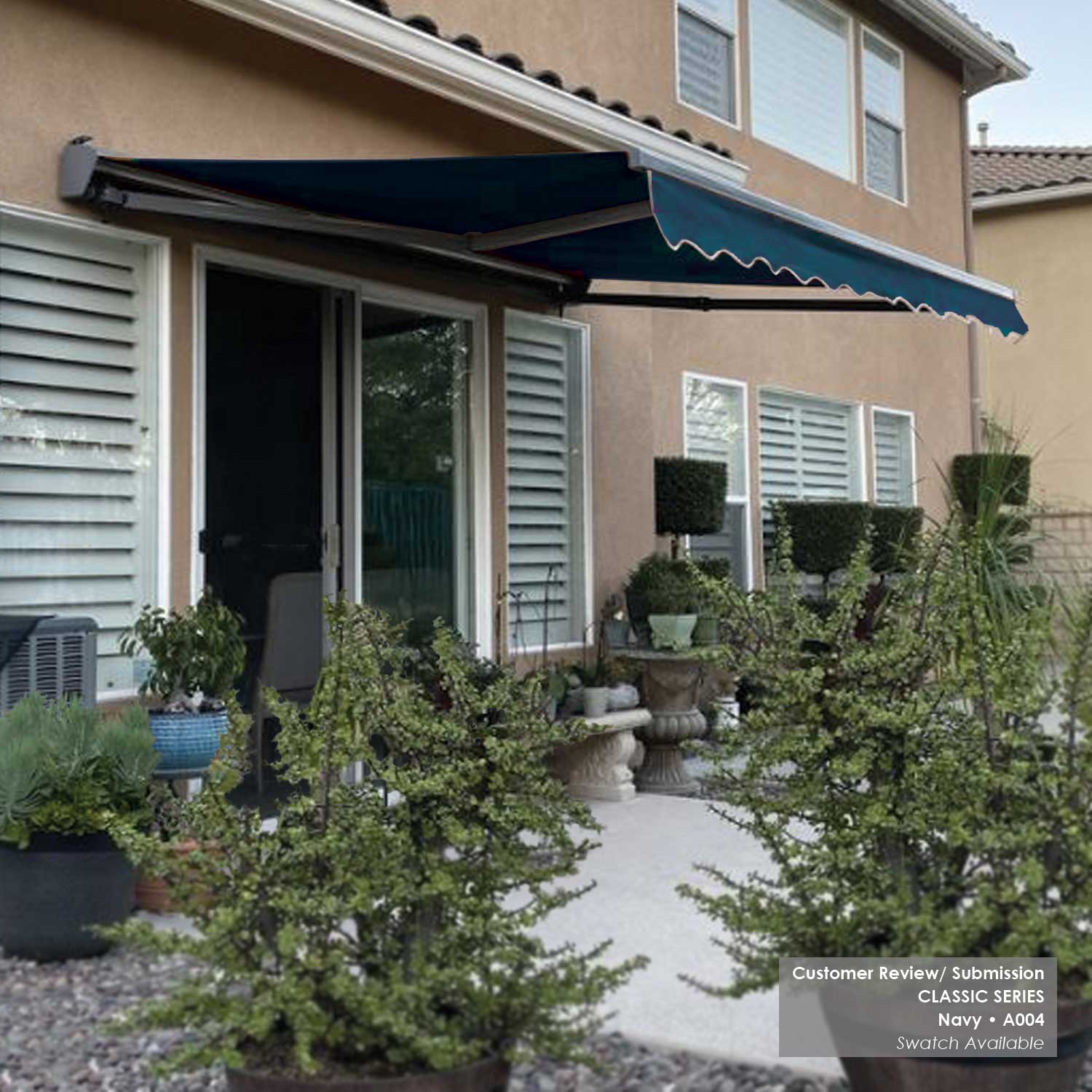 House exterior with a retractable awning A004 and potted plants.