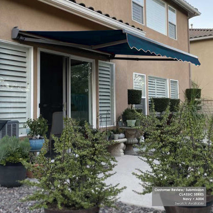House exterior with a retractable awning A004 and potted plants.