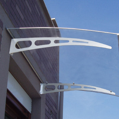 Metal canopy structure attached to a building against a clear blue sky
