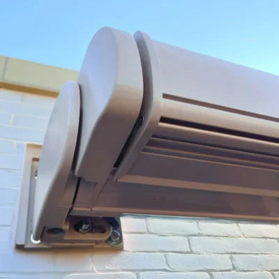 Outdoor light fixture on a wall with a clear blue sky background